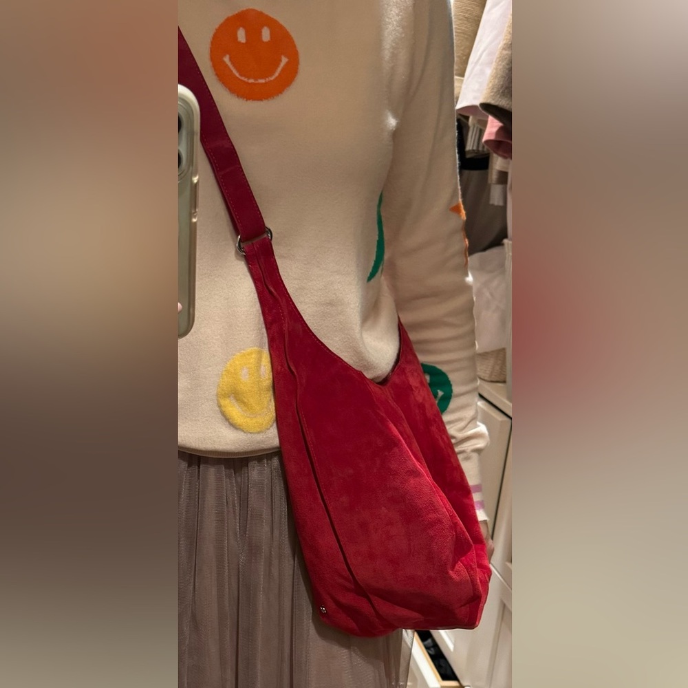 Red suede crossbody pouch by Halston, open top, has 2 inside pockets (one zips).
